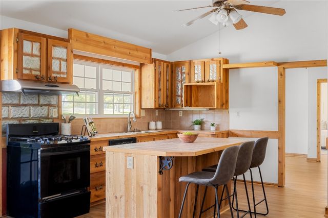 a kitchen that has a stove and a table