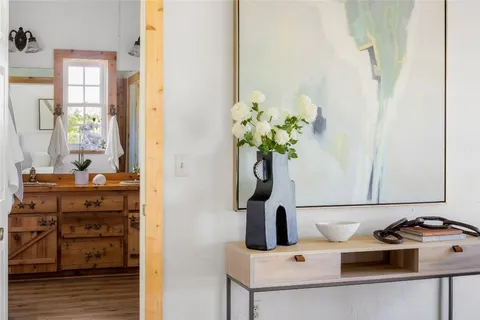 a dining room with furniture and a potted plant