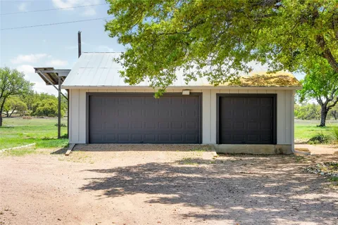 a view of a yard with a tree