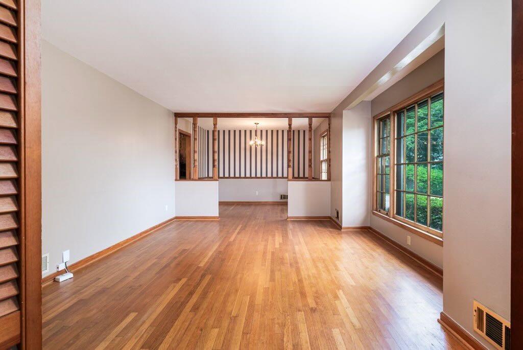 3854 Ridgewood Drive Southeast Smyrna, GA 30080 - Photo 12 of 40 an empty room with wooden floor and windows