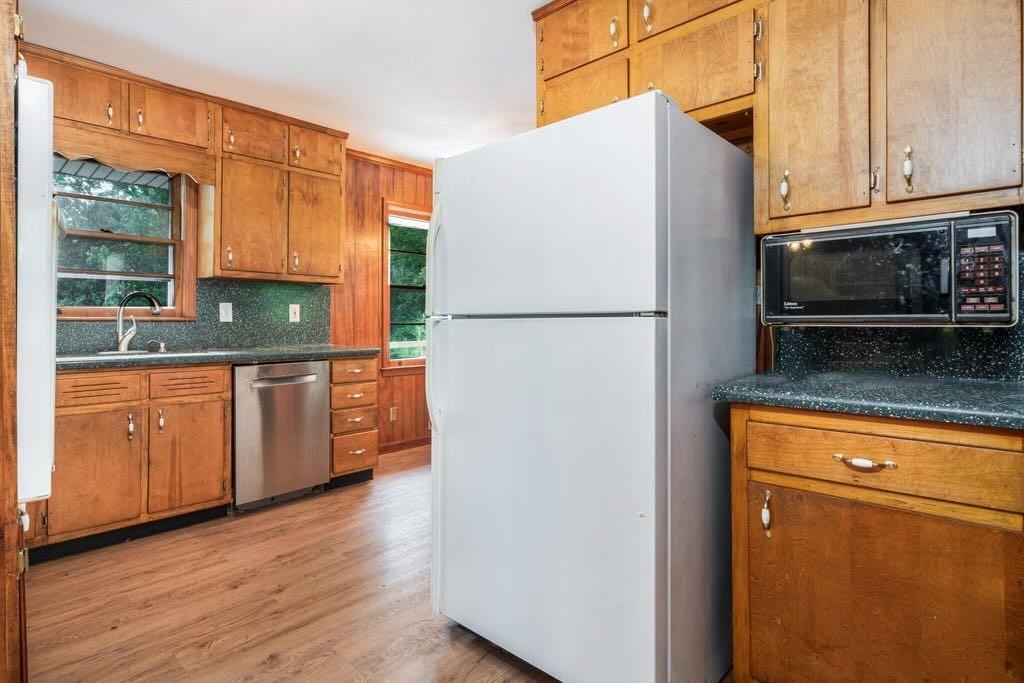3854 Ridgewood Drive Southeast Smyrna, GA 30080 - Photo 17 of 40 a kitchen with granite countertop a refrigerator stove and microwave