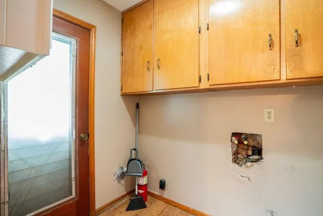 a view of storage and utility room with windows