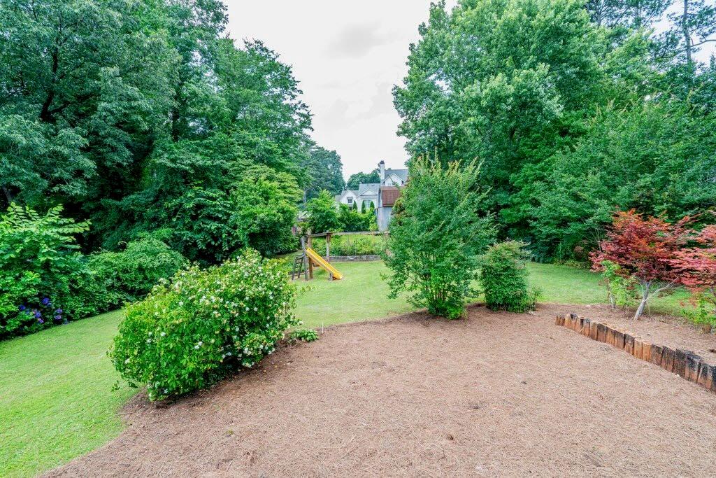 3854 Ridgewood Drive Southeast Smyrna, GA 30080 - Photo 31 of 40 a view of a road with plants and trees beside of it