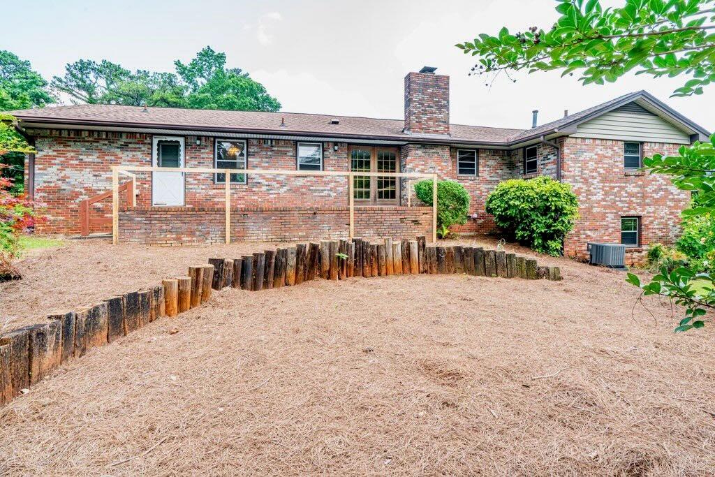 3854 Ridgewood Drive Southeast Smyrna, GA 30080 - Photo 32 of 40 a view of a house with wooden deck and a yard
