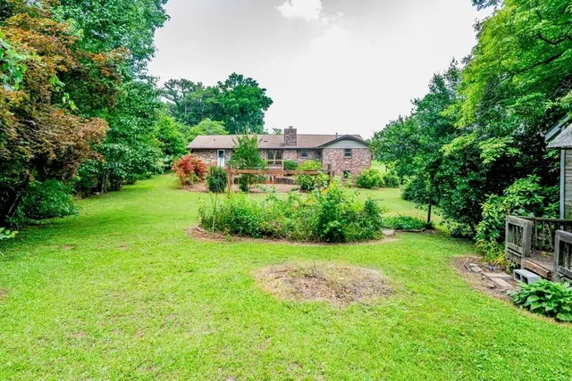 a view of a garden with a building in the background