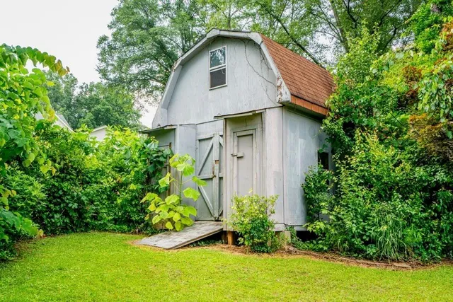 a front view of house with a garden