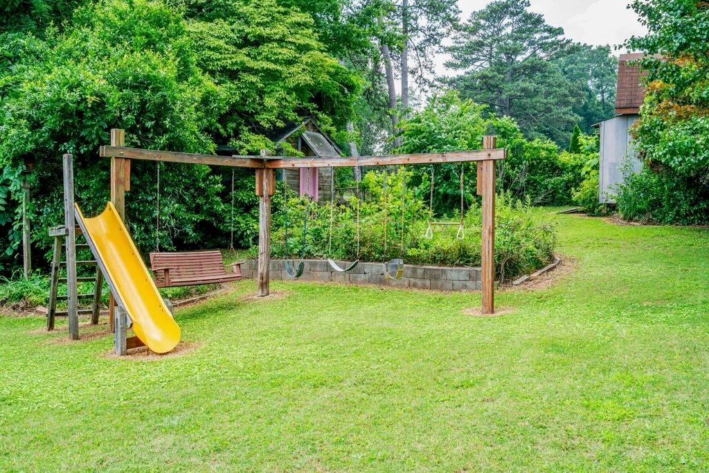 3854 Ridgewood Drive Southeast Smyrna, GA 30080 - Photo 40 of 40 a view of a backyard with a slide and wooden fence