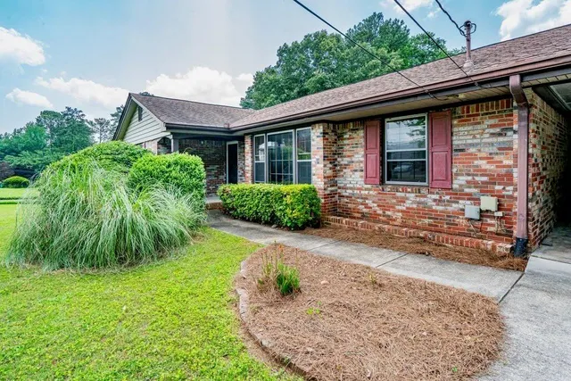 a front view of a house with a yard