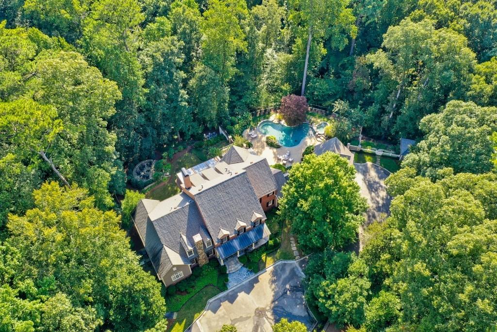 an aerial view of a house with a yard