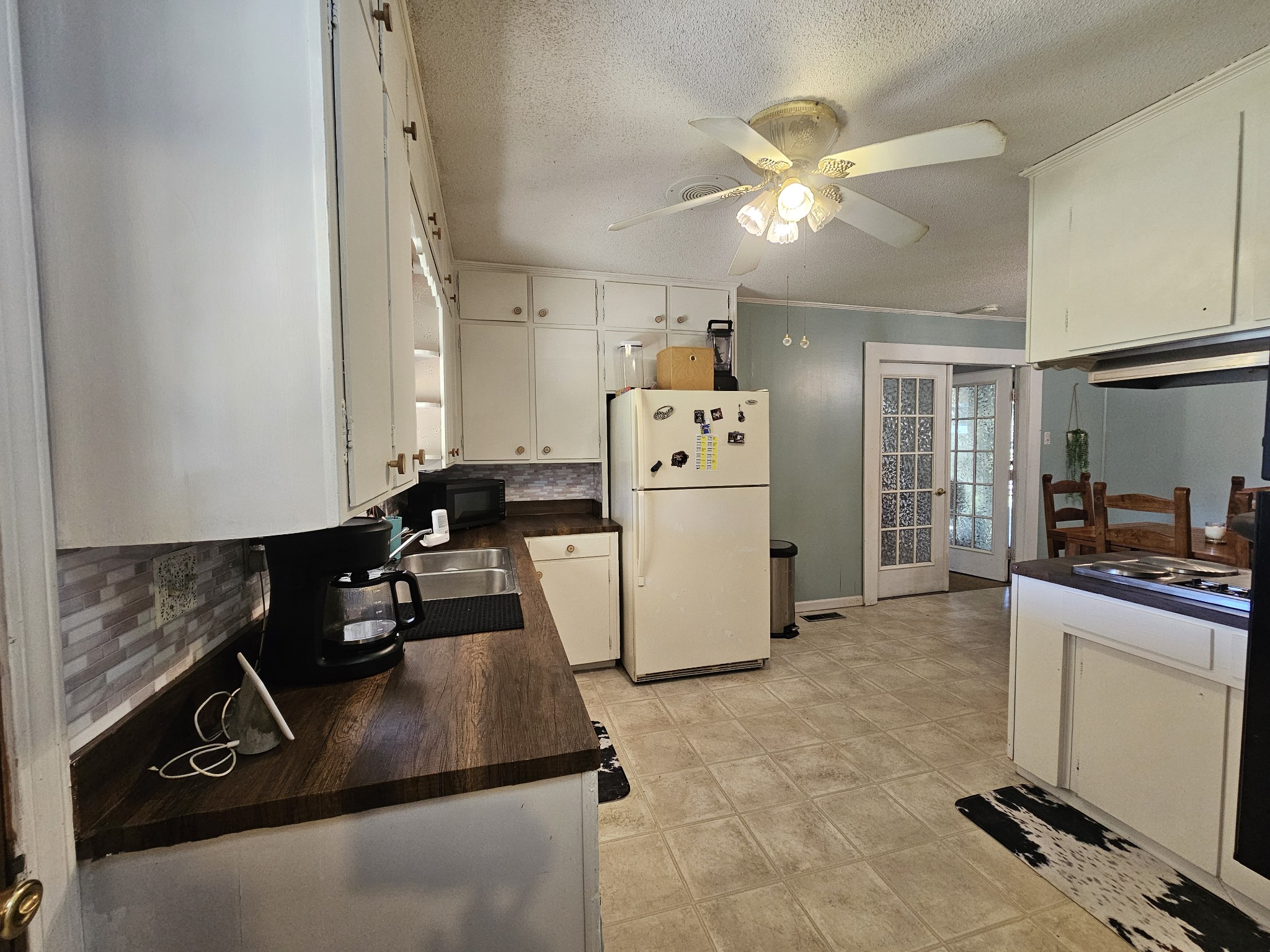 2122 Old Decaturville Road Parsons, TN 38363 - Photo 16 of 37 a kitchen with refrigerator a stove a sink dishwasher and a refrigerator with wooden floor