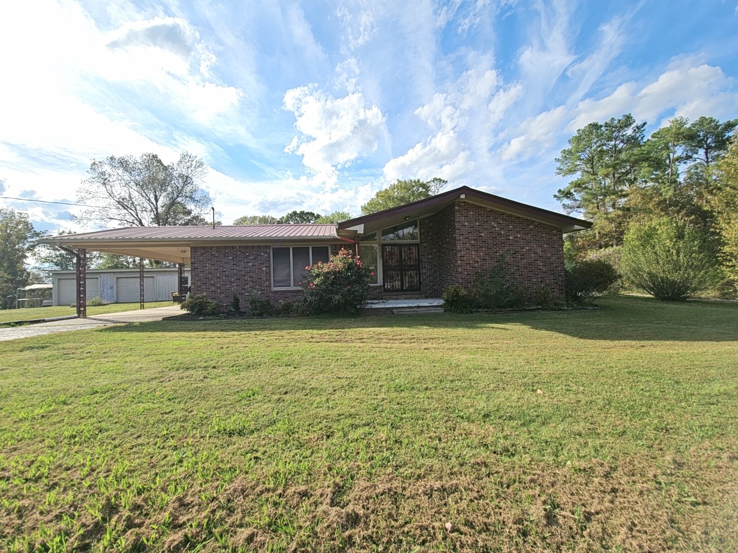 2122 Old Decaturville Road Parsons, TN 38363 - Photo 3 of 37 a front view of a house with a garden