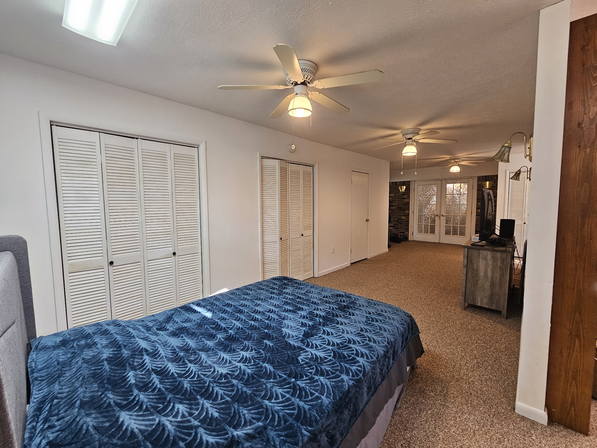 2122 Old Decaturville Road Parsons, TN 38363 - Photo 34 of 37 a spacious bedroom with a bed and a chandelier