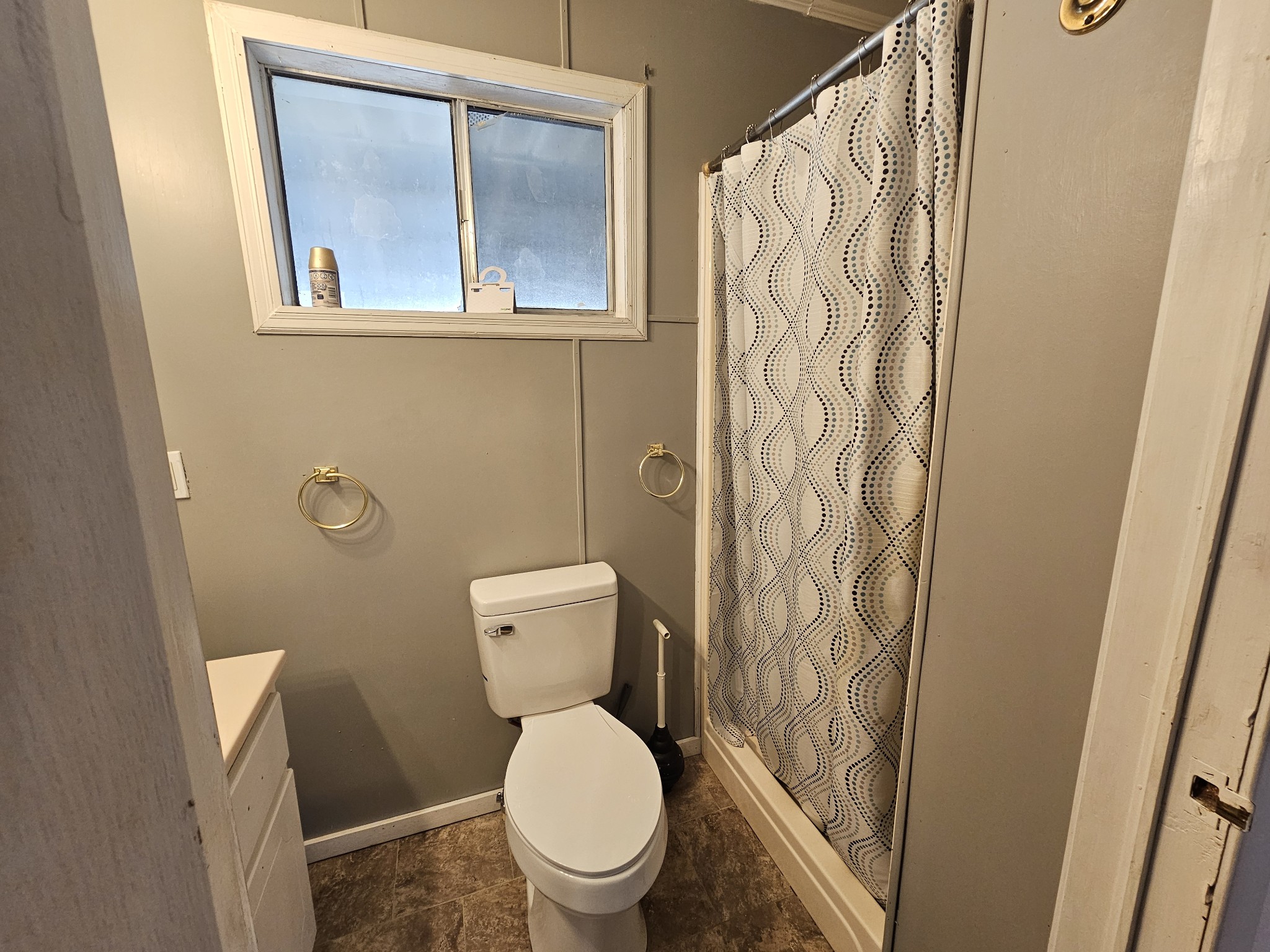 2122 Old Decaturville Road Parsons, TN 38363 - Photo 36 of 37 a white toilet sitting next to a shower curtain