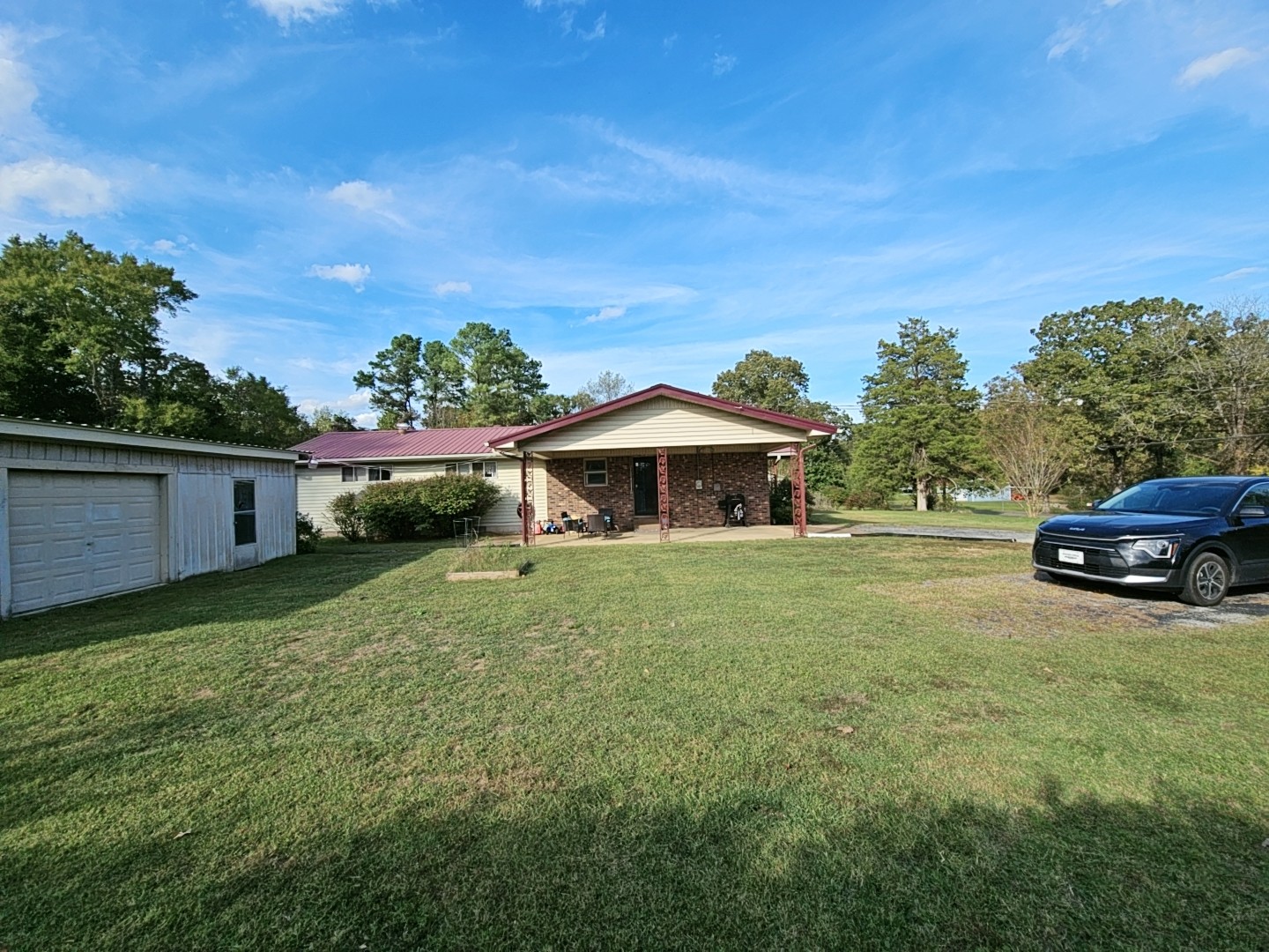 2122 Old Decaturville Road Parsons, TN 38363 - Photo 7 of 37 a house with trees in the background