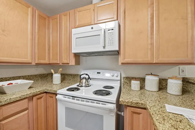 a kitchen with a sink a stove and cabinets