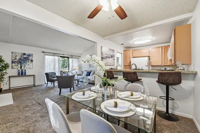 a dining room with furniture and a large window