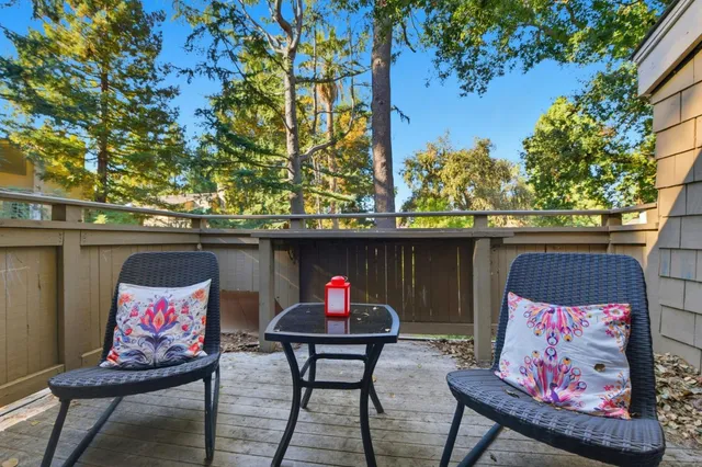 a roof deck with table and chairs