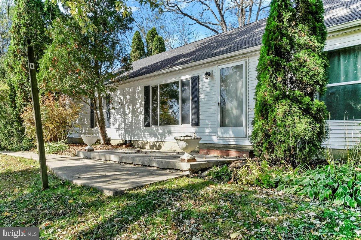 Charming home with lush greenery and patio.