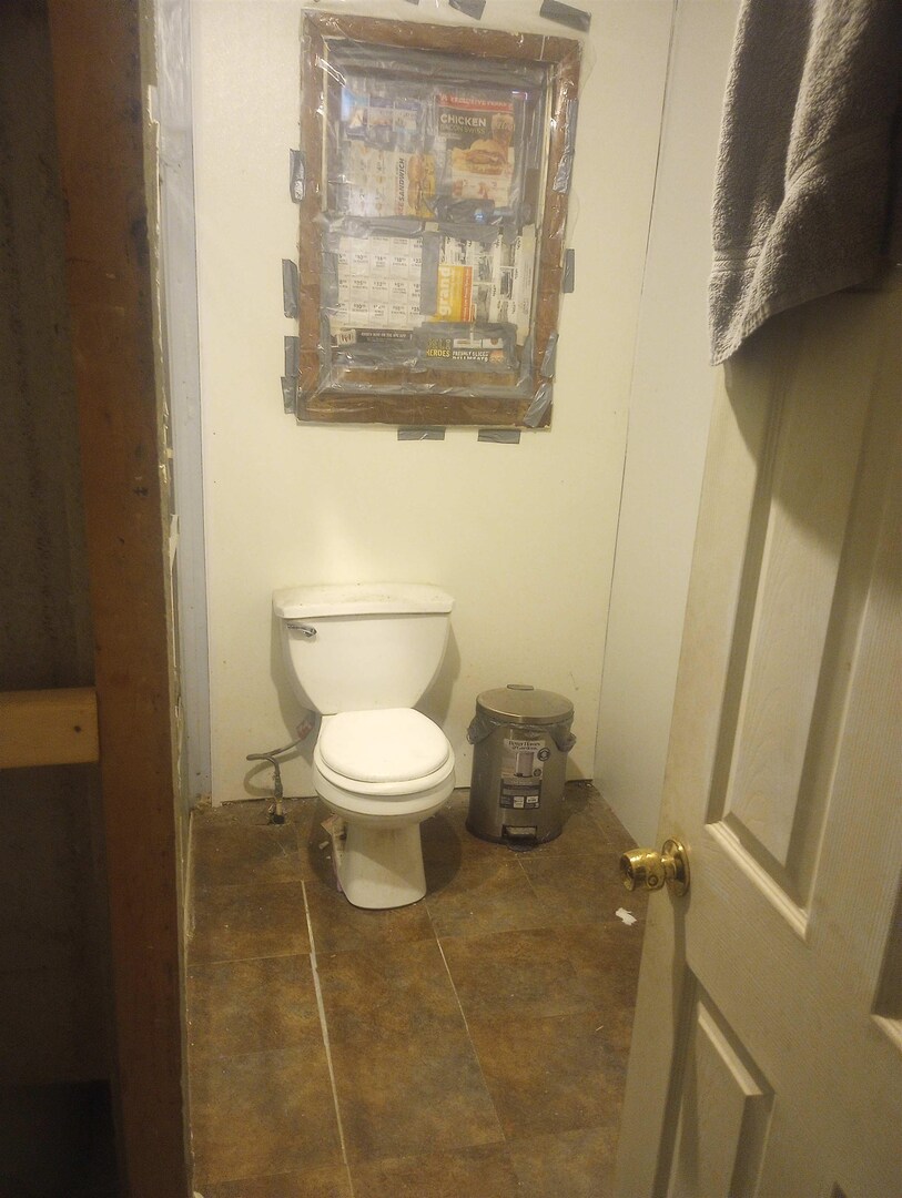 1815 North 14th Street Herrin, IL 62948 - Photo 5 of 6 a white toilet sitting next to a white sink and vanity