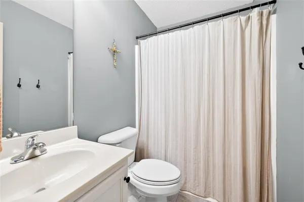 a bathroom with a toilet a sink and a mirror