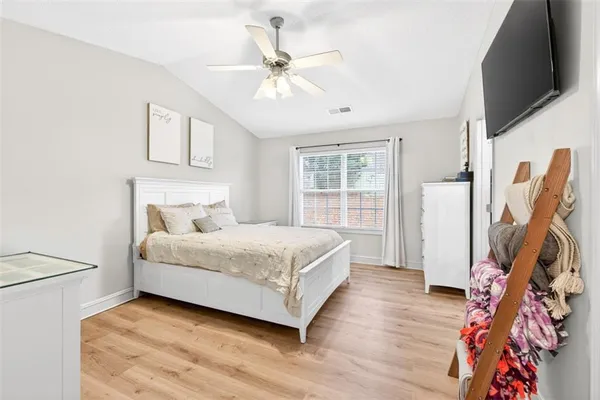 a bedroom with a bed and a flat screen tv