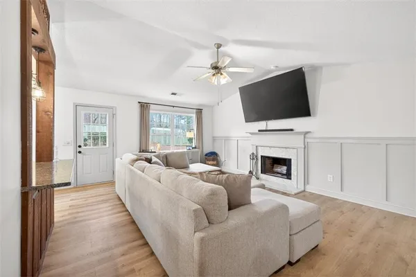 a living room with furniture a fireplace and a flat screen tv