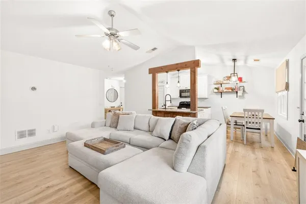 a living room with furniture and a chandelier