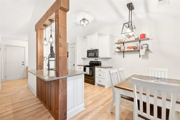 a kitchen with a refrigerator and a stove top oven