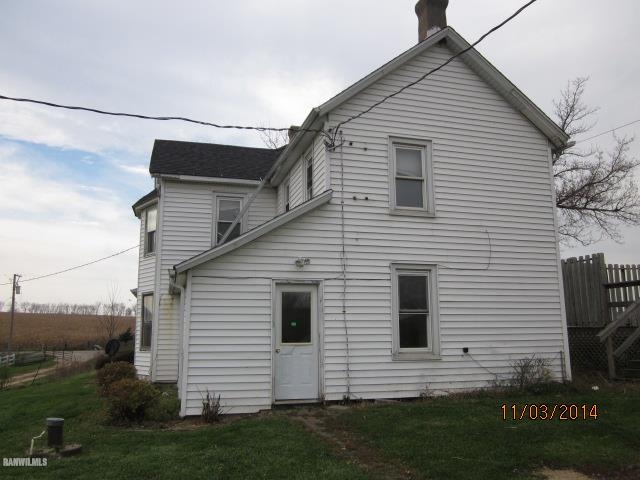 2405 North Henderson Road Freeport, IL 61032 - Photo 17 of 25 a view of a white house next to a yard