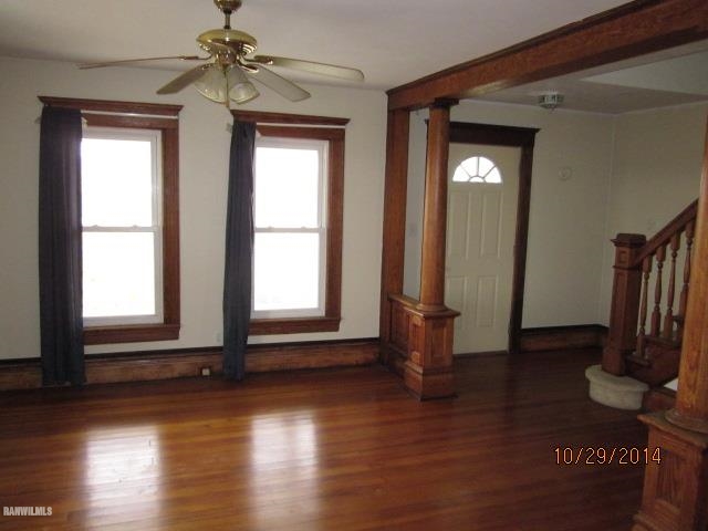 2405 North Henderson Road Freeport, IL 61032 - Photo 3 of 25 an empty room with wooden floor and windows