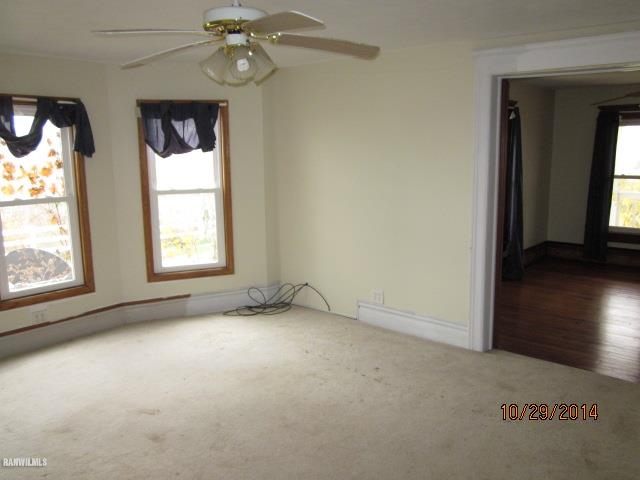2405 North Henderson Road Freeport, IL 61032 - Photo 5 of 25 an empty room with a windows and chandelier fan
