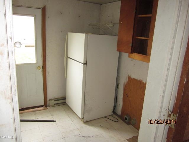 2405 North Henderson Road Freeport, IL 61032 - Photo 9 of 25 a view of a refrigerator in kitchen and an empty room