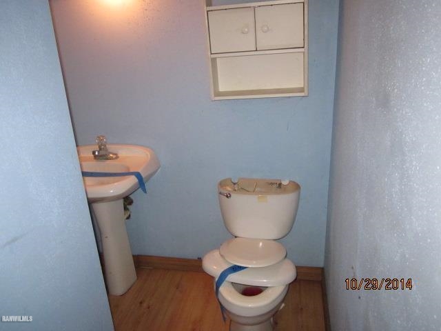 2405 North Henderson Road Freeport, IL 61032 - Photo 10 of 25 a white toilet sitting in a bathroom next to a sink