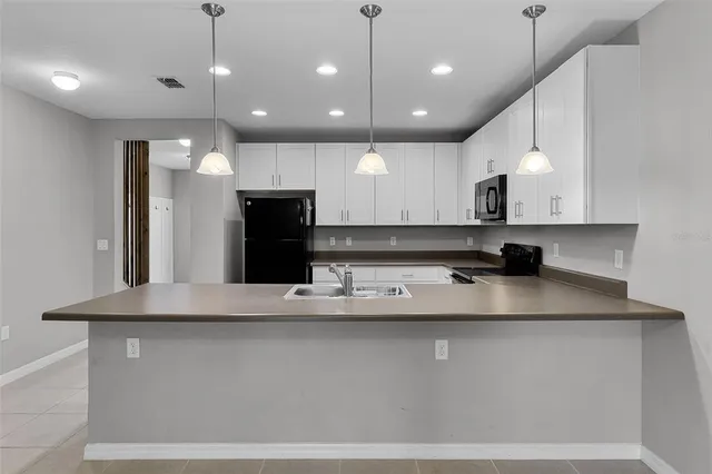 a view of kitchen with kitchen island and stainless steel appliances