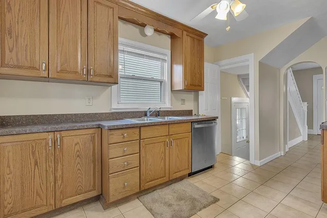 a kitchen with granite countertop cabinets and window