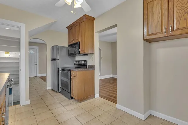 a kitchen with refrigerator and cabinets