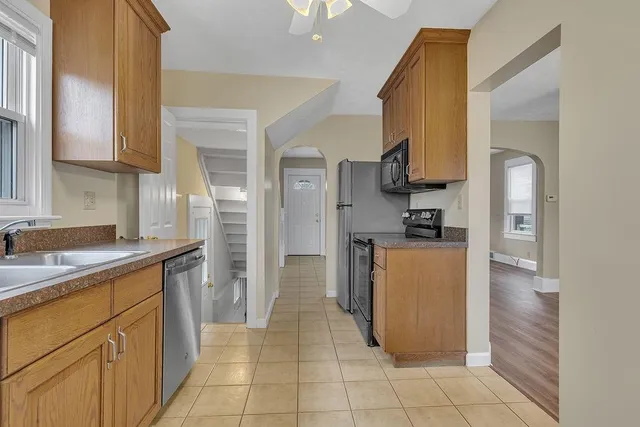 a kitchen with a sink cabinets and a refrigerator