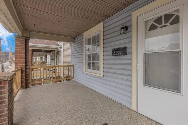 a porch with a table and chairs