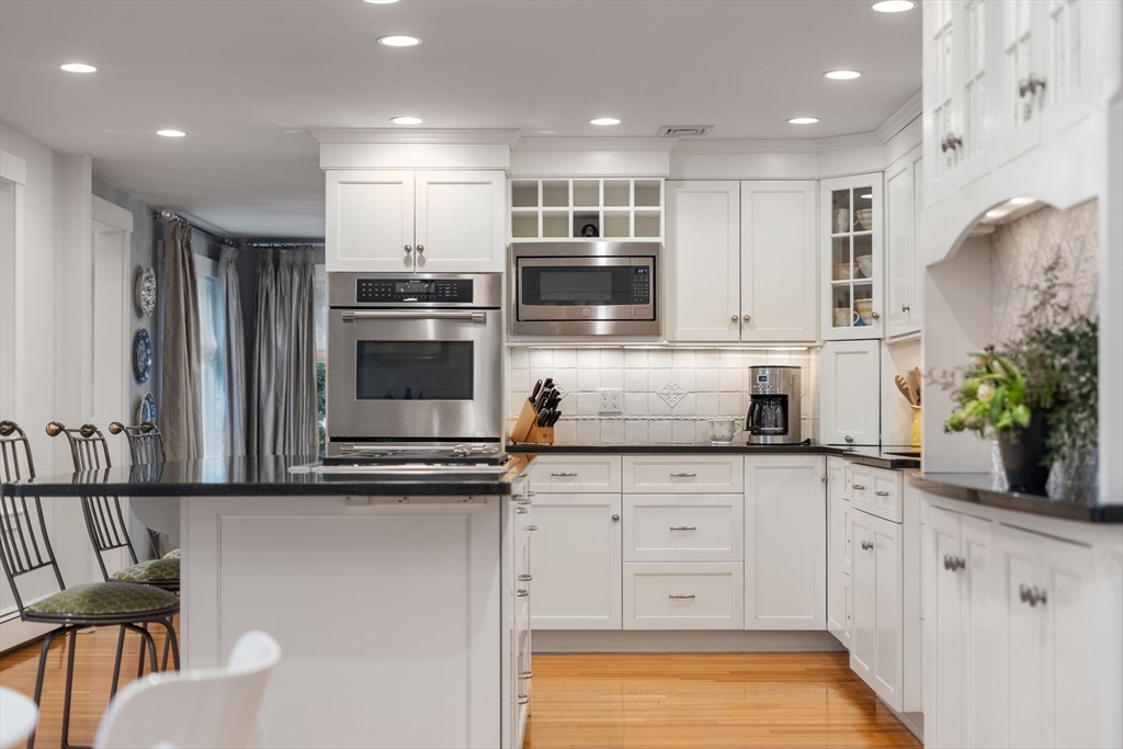 81 Woodfall Road Belmont, MA 02478 - Photo 9 of 37 a kitchen with stainless steel appliances granite countertop a stove a sink and a microwave