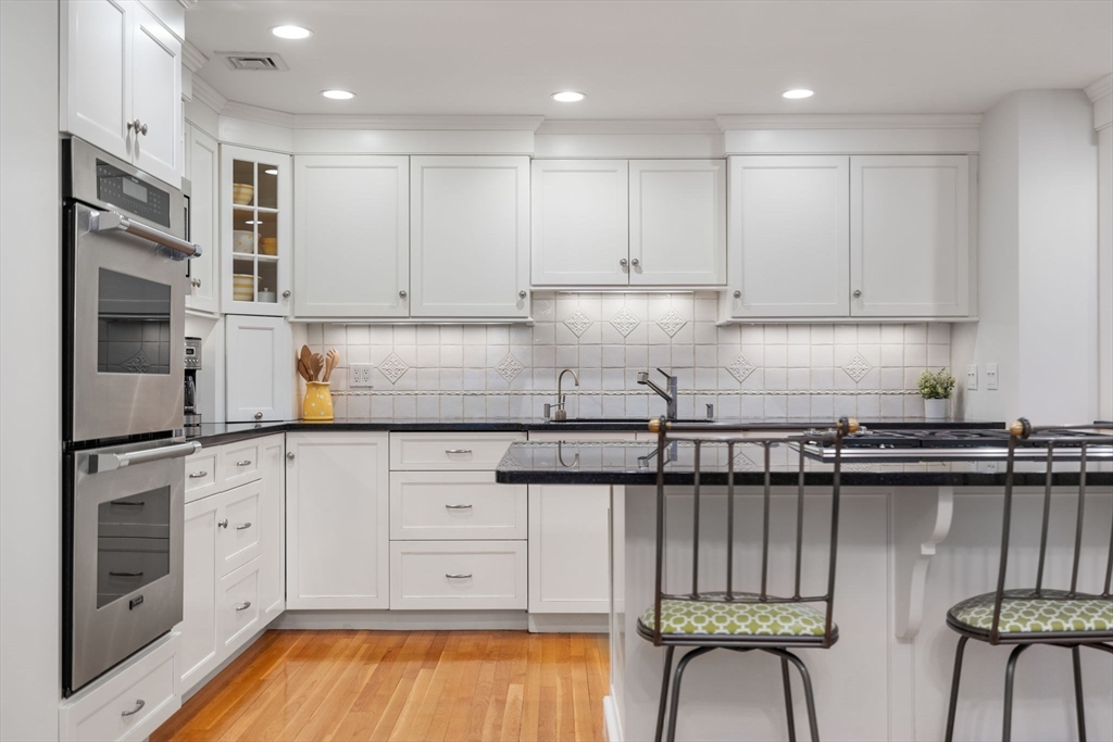81 Woodfall Road Belmont, MA 02478 - Photo 10 of 37 a kitchen with granite countertop white cabinets and stainless steel appliances