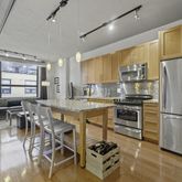 a kitchen with a table chairs refrigerator and cabinets