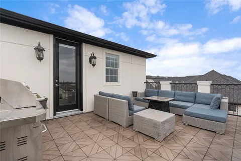 a backyard of a house with fire pit and couch