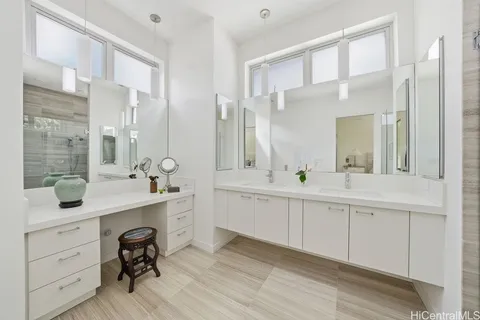 a spacious bathroom with a double vanity sink mirror and