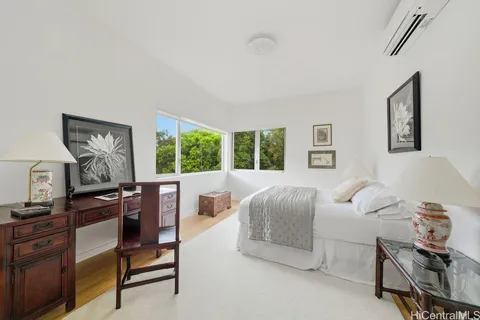 a bedroom with furniture and a window