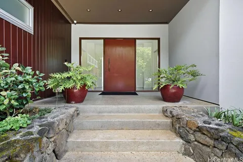 a building with potted plants in front of door