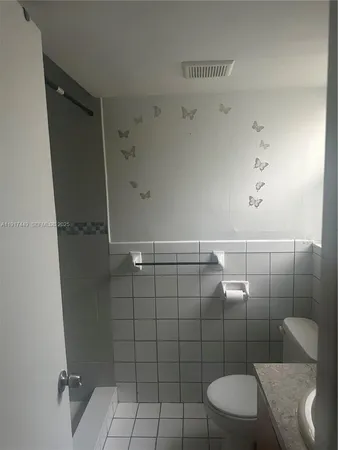 a view of an empty room and a window