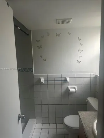 a view of an empty room and a window