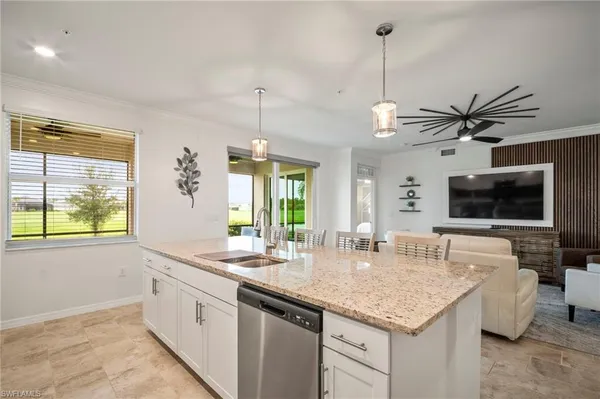 a kitchen with granite countertop a sink and a window