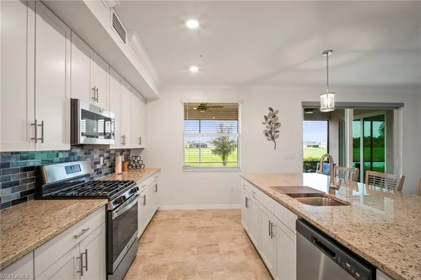 a open kitchen with stainless steel appliances granite countertop a sink stove and refrigerator