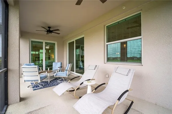 a living room with furniture and floor to ceiling windows